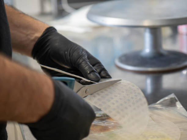 istock pastry chef preparing watering red dry rice paper sails for layer cake decoration 1445045641