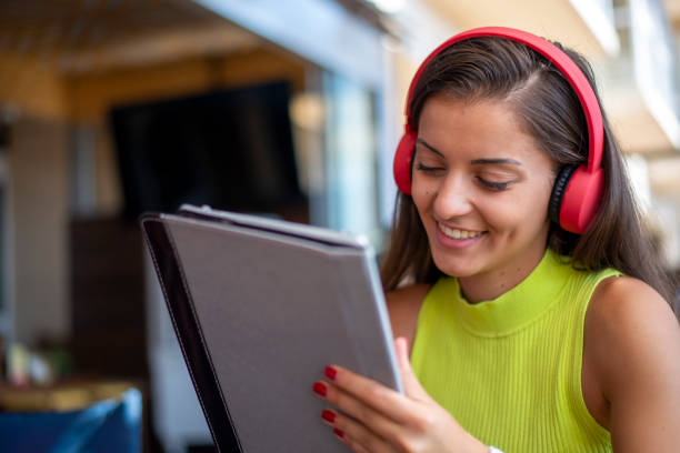 istock A young woman uses a tablet in a cafe. 1445045811