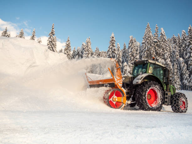 istock Snowblower grader clears snow covered road 1445051578