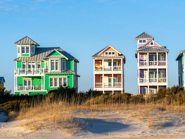 istock Colorful Beach Vacation Homes Behind Dunes Right at Sunset 1445055825