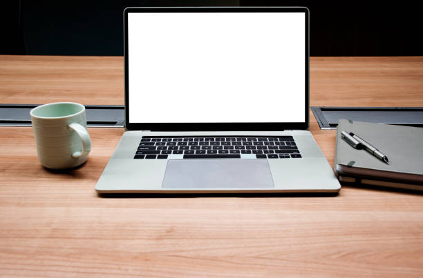 Office desk with laptop computer and digital tablet on top