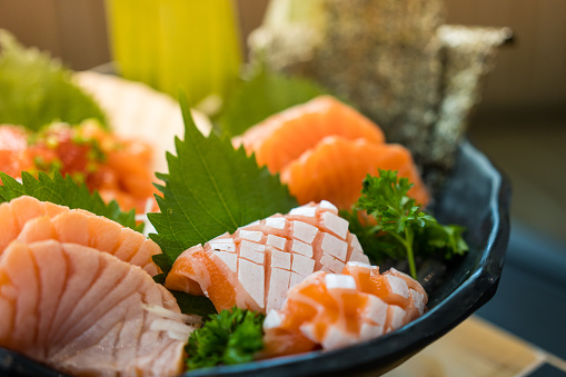 A famous Japanese menu is salmon sashimi. Selective focus