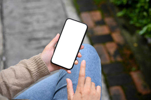 istock Top view, A female using her smartphone while relaxes sitting in the garden or backyard 1445066822