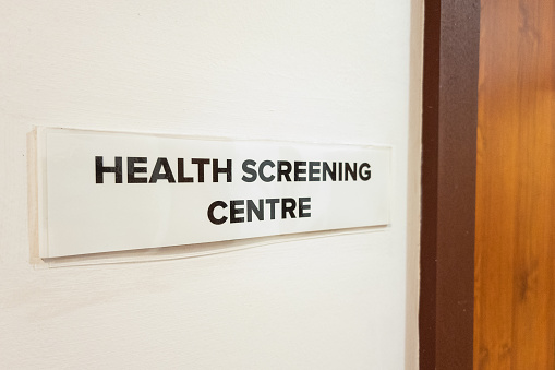 Concept of the word Health Screening Centre at the door entrance of hospital or medical clinic