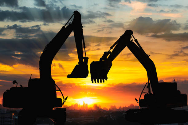 Two Black silhouette of backhoe loader.