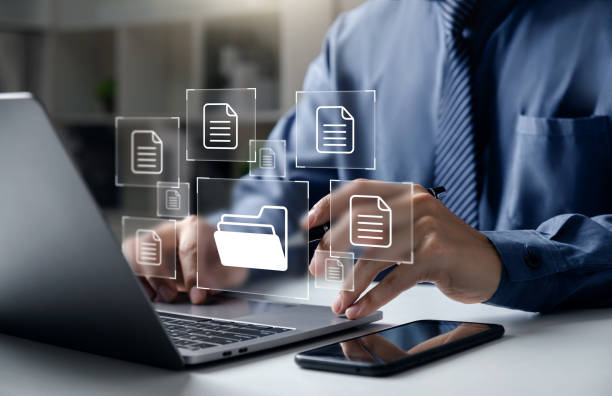Businessman pointing folder and document Document Management System DMS, Businessman pointing to folder and document, system used to create, store, manage, and track electronic document. Stream stock pictures, royalty-free photos & images