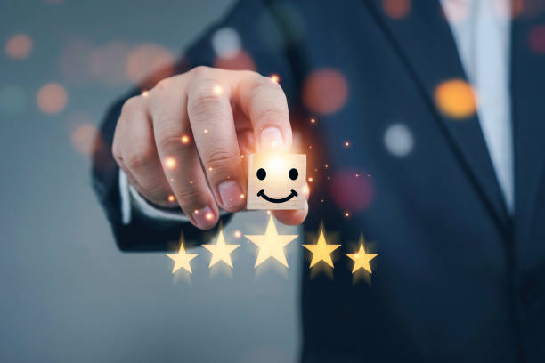 istock best excellent business services rating customer experience. Satisfaction survey concept. Hand of a businessman chooses a smiley face on wood block cube. 5 Star Satisfaction. 1445075339