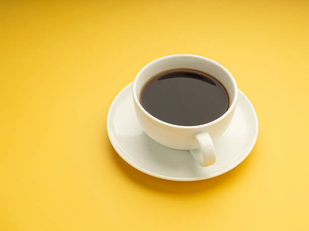 istock A side view of a white coffee cup is on a yellow background. 1445077894