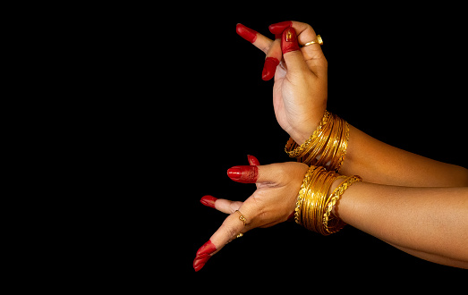 Indian woman classical dancer hands demonstrating mudras or gestures of Bharatanatyam classical dance.