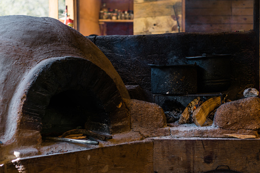 Traditional rural kitchen of firewood with stone oven, no people. Cooking.