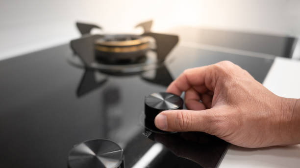 istock Male hand turning switch knob on gas stove 1445084559