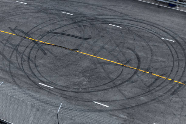 istock Tire tracks texture and background, Asphalt texture with line and tire marks, Automobile automotive tire skid mark on race track, Abstract texture car drift tire skid mark. 1445085249