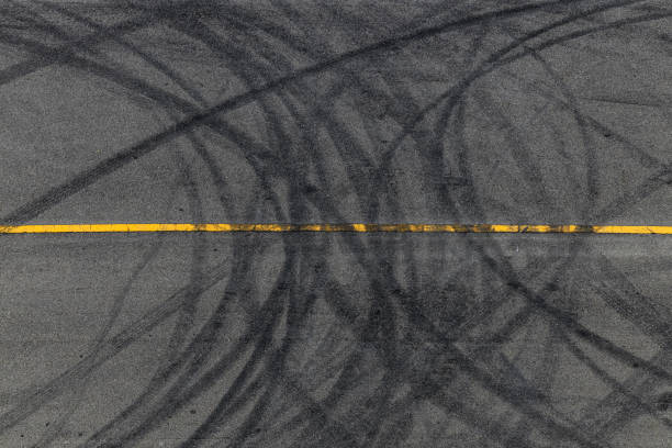istock Tire tracks texture and background, Asphalt texture with line and tire marks, Automobile automotive tire skid mark on race track, Abstract texture car drift tire skid mark. 1445085293