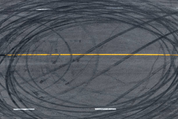 istock Tire tracks texture and background, Asphalt texture with line and tire marks, Automobile automotive tire skid mark on race track, Abstract texture car drift tire skid mark. 1445085300