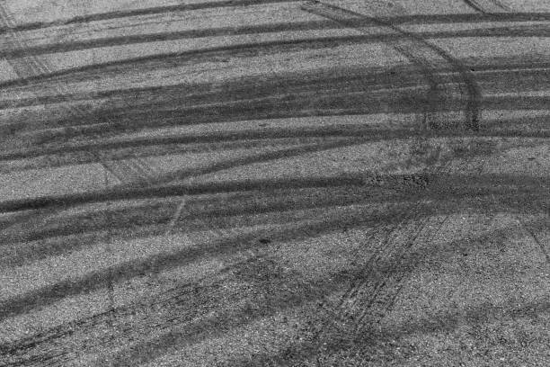 istock Tire tracks texture and background, Asphalt texture with line and tire marks, Automobile automotive tire skid mark on race track, Abstract texture car drift tire skid mark. 1445085308