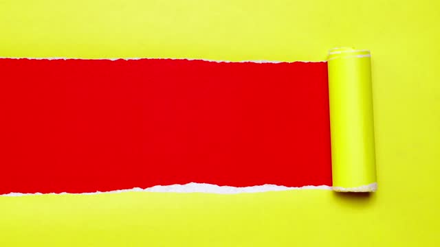 4k : stop motion of yellow paper is torn over red background, christmas concept