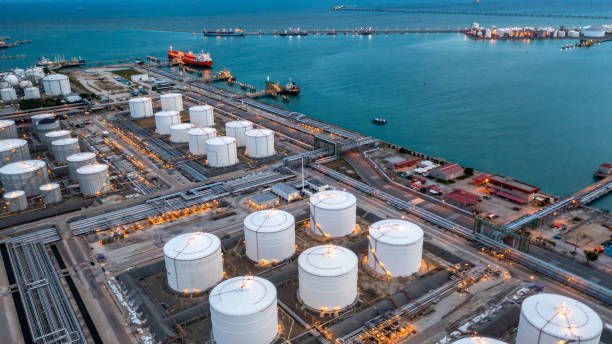 aerial view oil terminal industrial facility storage tank oil and petrochemical product for transport to further storage facility, storage tank petroleum petrochemical refinery product at oil terminal - oil storage tank storage compartment fuel and power generation imagens e fotografias de stock