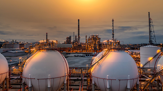 Gas storage sphere tank in petrochemical industry zone with oil and gas refinery factory plant petrochemical industry and oil storage tank background, Oil refinery at twilight.