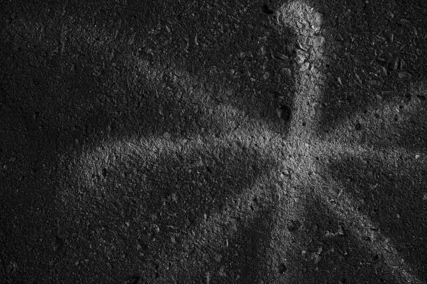White Asterisk Sign on Black Grunge Concrete Wall Texture Background.