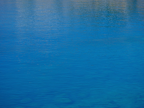 Dark smooth water surface in a lake, water background