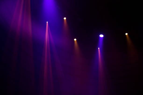 Purple beams of light from stage spotlights on a dark background. Purple beams of light from stage spotlights on a dark background. disco lights stock pictures, royalty-free photos & images