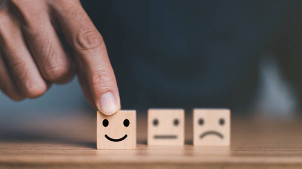 istock Close up customer hand choose smile face and blurred sad face icon on wood cube, Service rating, Customer service evaluation and satisfaction survey concepts. 1445101161