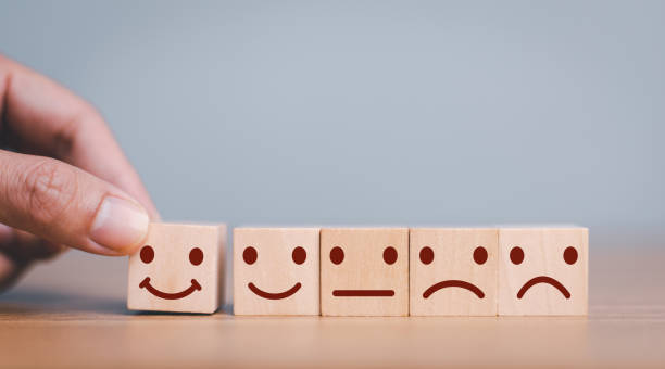 istock Hand move up wooden cube block which  smile face  for client customer satisfaction after use product and service concept. 1445101302