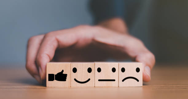 istock Close up customer hand choose smile face and blurred sad face icon on wood cube, Service rating, Customer service evaluation and satisfaction survey concepts. 1445102019