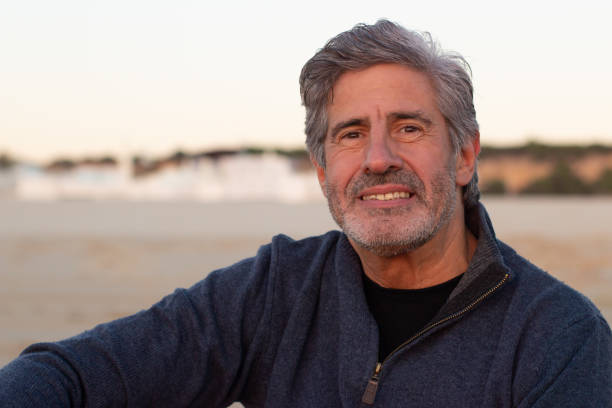 Portrait of grey-haired senior man spending time outside