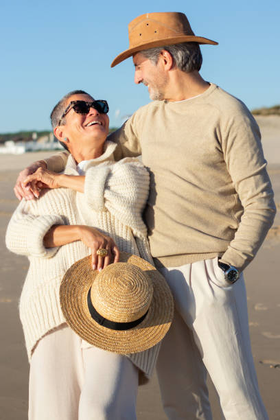 istock Happy senior couple having fun at seashore hugging and smiling 1445103214