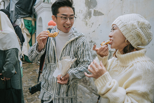 Asian Chinese Tourist couple enjoying local traditional food at Tetouan Market