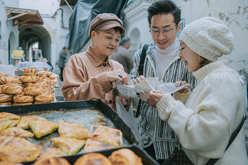 Asian Chinese Tourist enjoying local traditional food at Tetouan Market