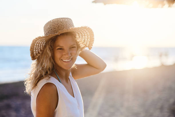 istock Happy woman enjoying while spending summer day on the beach. 1445112187