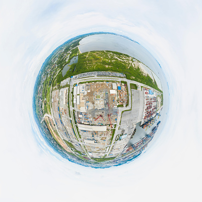 360 Degree Spherical panorama of New Construction site with cranes and construction machinery. Container ship loading and unloading, Cargo container in deep seaport for the international order concept.