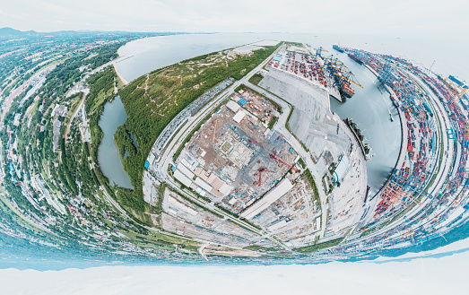 360 Wide Panoramic image of Container ship loading and unloading, Cargo container in deep seaport for the international order concept.  New Construction site with cranes and construction machinery.