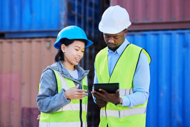 istock Logistics, tablet and employees planning delivery of shipping container on technology while working together at a port. Outdoor warehouse workers working on inventory of cargo at a storage plant 1445119445