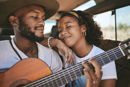 Road trip, guitar music and black couple on drive for adventure and travel on a summer vacation during romantic song moment. Happy man and woman using instrument on motor transport getaway with love
