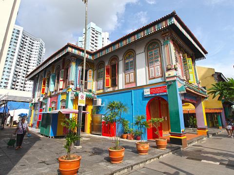 A person walking by the Tan Teng Niah house Little India Singapore. Built in 1900 this ancient Chinese building in Little India is now a tourist attraction, popular due to it's vivid colours.