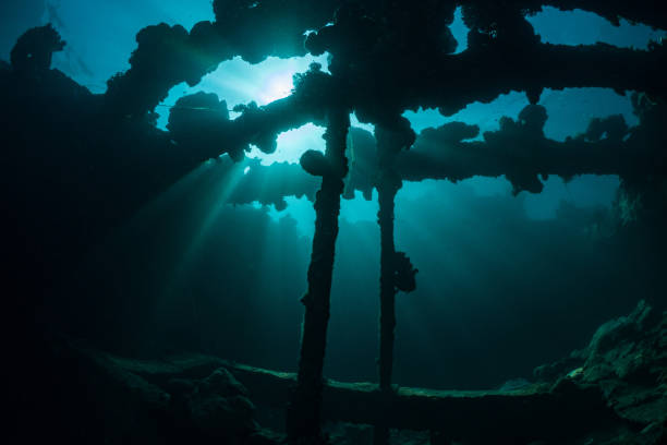istock Sunrays burst through the water above wreck in the Ocean 1445121557