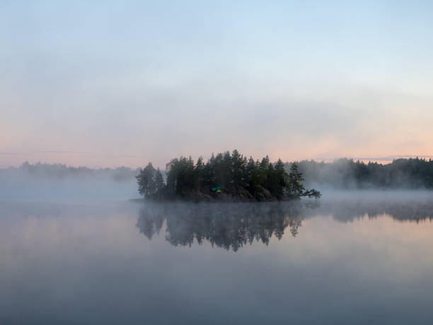 istock island with a tent on a forest lake 1445123881