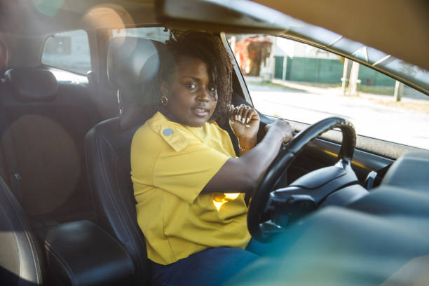 istock Young woman smiling at camera while fastening her seat belt 1445124645