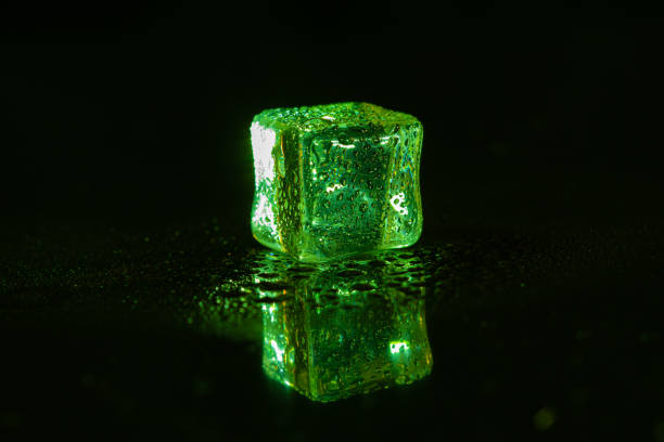 istock Green ice cubes on black background. 1445125128