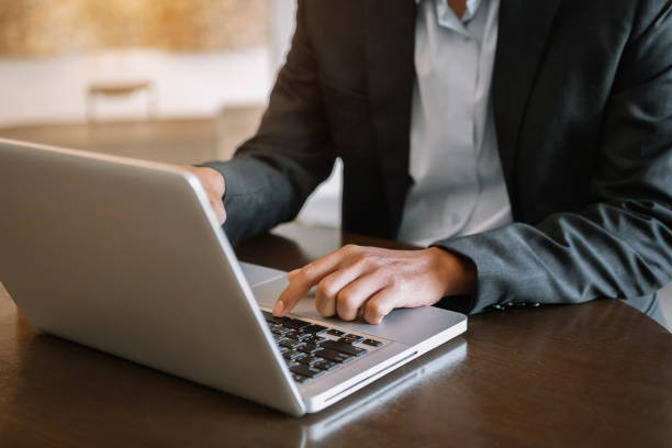 istock Man hands is typing on a laptop and holding tablet 1445125439