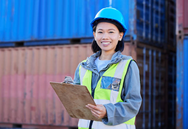 istock Logistics, cargo and a woman with inventory checklist on clipboard. Container yard, supply chain and happy shipping port employee from Japan. Smile, manager or inspector global freight company depot. 1445125465