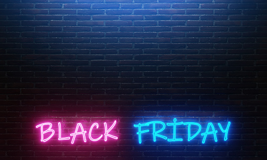 Neon lighting and neon colored Black Friday text on the dark wall background