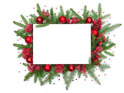 Traditional merry christmas frame with confetti for mockup or design template. Christmas background with Christmas wreath of fir branches decorated with glass balls and viburnum branches.