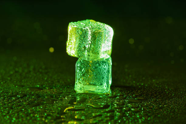 istock Green ice cubes on black background. 1445126714