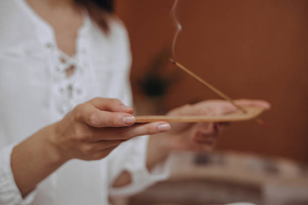 istock Female with incense stick at home 1445126902