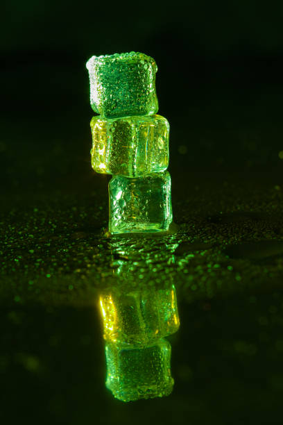 istock Green ice cubes on black background. 1445126940