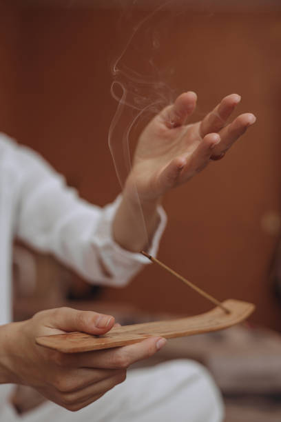istock Female with burning incense stick enjoying aromatherapy 1445126954